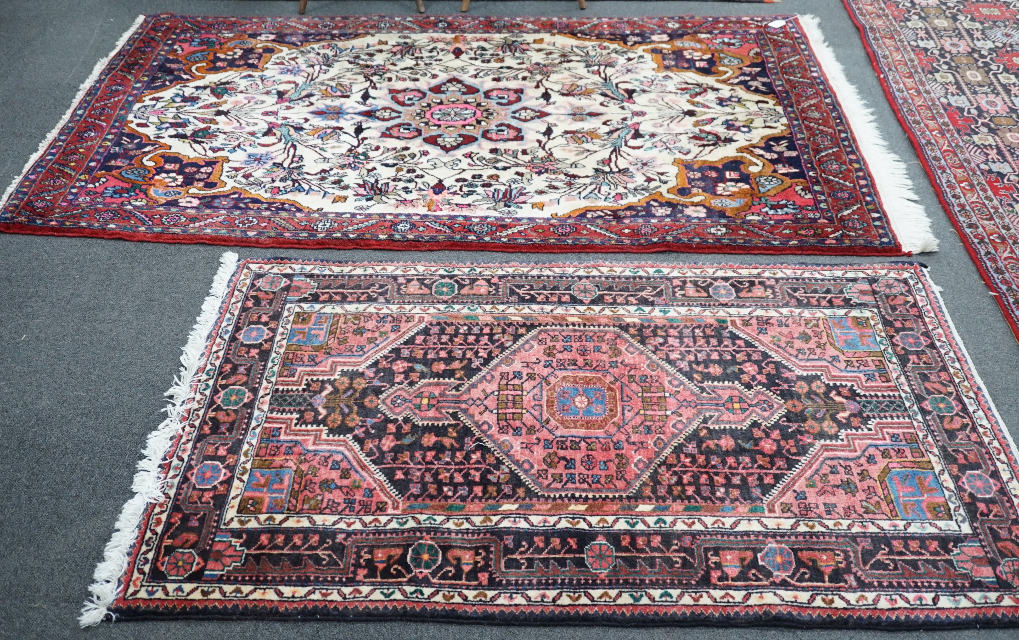 A North West Persian ivory ground rug, 220 x 140cm, and a smaller blue ground rug